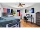 Well-lit bedroom with natural light, a wooden bed frame, hardwood floors, and a dedicated workspace at 585 Cokesbury Rd, Fuquay Varina, NC 27526