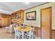 Dining area featuring wooden cabinets, a cozy table setting, and warm lighting at 585 Cokesbury Rd, Fuquay Varina, NC 27526