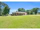 Charming brick ranch-style home with a large front yard and extended driveway leading to a garage at 585 Cokesbury Rd, Fuquay Varina, NC 27526