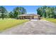 Quaint brick ranch-style home featuring a lush lawn, ample parking, and an attached garage at 585 Cokesbury Rd, Fuquay Varina, NC 27526