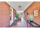 Long, brick-lined hallway with decorative plants, offering a welcoming entrance to the home at 585 Cokesbury Rd, Fuquay Varina, NC 27526