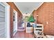 Long, brick-lined hallway with outdoor views, showing a glimpse of the surrounding greenery at 585 Cokesbury Rd, Fuquay Varina, NC 27526