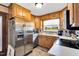 Well-lit kitchen featuring stainless steel appliances, bright countertops, and view of the backyard at 585 Cokesbury Rd, Fuquay Varina, NC 27526