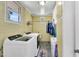 Functional laundry room with washer, dryer, sink, and storage, creating convenience at 585 Cokesbury Rd, Fuquay Varina, NC 27526