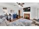 Bright living room featuring a brick fireplace, hardwood floors, and an open concept workspace at 585 Cokesbury Rd, Fuquay Varina, NC 27526