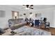 Inviting living room featuring a hardwood floor, ceiling fan, and a comfortable seating arrangement at 585 Cokesbury Rd, Fuquay Varina, NC 27526