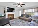Cozy living room featuring a ceiling fan, fireplace, neutral paint, and hardwood floors at 585 Cokesbury Rd, Fuquay Varina, NC 27526