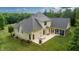 Spacious backyard with a patio area, ideal for outdoor entertaining, surrounded by mature trees at 639 Cedar Grove Rd, Pittsboro, NC 27312