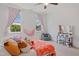 Comfortable bedroom with large windows, carpeting and a beanbag at 639 Cedar Grove Rd, Pittsboro, NC 27312