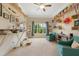 Bright bedroom featuring two blue armchairs, large windows, and custom-built shelving at 639 Cedar Grove Rd, Pittsboro, NC 27312