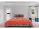 Bright bedroom with an outdoor access door, a bed dressed in patterned covers, and natural light at 639 Cedar Grove Rd, Pittsboro, NC 27312