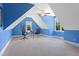 Bright bedroom featuring blue accent walls, two windows, and neutral carpeting at 639 Cedar Grove Rd, Pittsboro, NC 27312