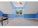 Bright bedroom featuring blue accent walls and a large window at 639 Cedar Grove Rd, Pittsboro, NC 27312