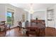 Elegant dining room with a large round table, hardwood floors, and a decorative chandelier at 639 Cedar Grove Rd, Pittsboro, NC 27312