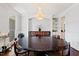 Spacious dining room featuring hardwood floors, chandelier, and built-in cabinet at 639 Cedar Grove Rd, Pittsboro, NC 27312