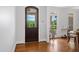 Bright foyer with a view into the adjacent dining room, showcasing beautiful hardwood floors and natural light at 639 Cedar Grove Rd, Pittsboro, NC 27312