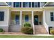 Inviting front porch featuring classic columns and ample space for seating, perfect for relaxing outdoors at 639 Cedar Grove Rd, Pittsboro, NC 27312