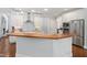 Well-lit kitchen with stainless steel appliances, custom cabinets, subway tile backsplash, and hardwood floors at 639 Cedar Grove Rd, Pittsboro, NC 27312