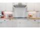Bright kitchen featuring granite countertops, subway tile backsplash, and stainless steel appliances at 639 Cedar Grove Rd, Pittsboro, NC 27312