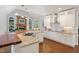 Bright kitchen with stainless steel appliances, custom cabinets, granite countertops, and wood-burning fireplace at 639 Cedar Grove Rd, Pittsboro, NC 27312