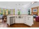Bright kitchen with stainless steel appliances, custom cabinets, granite countertops, and stainless farmhouse sink at 639 Cedar Grove Rd, Pittsboro, NC 27312