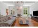 Cozy living room with hardwood floors, fireplace, comfortable seating, and natural light at 639 Cedar Grove Rd, Pittsboro, NC 27312