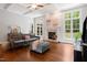 Comfortable living room featuring hardwood floors, fireplace, and ceiling beams at 639 Cedar Grove Rd, Pittsboro, NC 27312