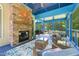 Outdoor patio featuring a stone fireplace, outdoor seating, blue walls, and a ceiling fan at 639 Cedar Grove Rd, Pittsboro, NC 27312