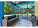 Inviting screened porch with comfortable seating, a wooden table set, and views of lush greenery at 639 Cedar Grove Rd, Pittsboro, NC 27312