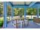 Charming porch with a wooden table, seating, and views of the surrounding nature at 639 Cedar Grove Rd, Pittsboro, NC 27312