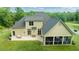 An aerial view of a home with a large backyard, screened porch, and patio sitting area at 639 Cedar Grove Rd, Pittsboro, NC 27312