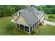 Aerial shot of a charming home featuring a screened in porch, patio, and well-maintained landscaping at 639 Cedar Grove Rd, Pittsboro, NC 27312