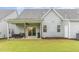 Back exterior featuring a covered patio with furniture and a grill, overlooking the lawn at 646 Shelford Trl, Zebulon, NC 27597