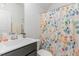 Bathroom featuring a vanity with solid surface top, and a shower with a colorful curtain at 646 Shelford Trl, Zebulon, NC 27597