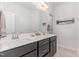 A bathroom featuring a dual vanity with dark cabinets and a large mirror and a white countertop at 646 Shelford Trl, Zebulon, NC 27597