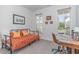 Bright bedroom featuring a daybed with patterned cover, desk, and windows offering neighborhood views at 646 Shelford Trl, Zebulon, NC 27597