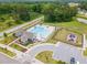Birds eye view of the swimming pool, playground, and nearby wooded area at 646 Shelford Trl, Zebulon, NC 27597