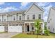 Charming two-story home featuring a stone-accented garage and inviting front porch at 646 Shelford Trl, Zebulon, NC 27597
