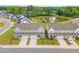 View of townhomes with attached garages with a pond in the background at 646 Shelford Trl, Zebulon, NC 27597