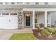 Inviting front entrance with a black door, decorative wreath, and cozy porch seating area at 646 Shelford Trl, Zebulon, NC 27597