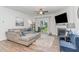 Bright living room with a comfortable sectional sofa, fireplace, and sliding door to the outdoor area at 646 Shelford Trl, Zebulon, NC 27597