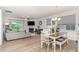 Open-concept living and dining area featuring a fireplace, stylish seating, and a dining table at 646 Shelford Trl, Zebulon, NC 27597