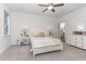 A bedroom with white furnishings and a ceiling fan and a view into an adjacent room at 646 Shelford Trl, Zebulon, NC 27597