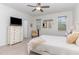 A bedroom with white furnishings, two windows and a view into the bath and a dresser at 646 Shelford Trl, Zebulon, NC 27597
