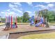 A vibrant community playground with multiple slides, climbing structures, and a safety-conscious mulch ground cover at 646 Shelford Trl, Zebulon, NC 27597