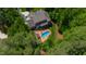 Aerial view of home featuring a pool and lush, wooded lot at 7116 Dumfries Ln, Chapel Hill, NC 27514