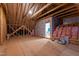 Unfinished attic space with exposed rafters, insulation, and potential for customization at 7116 Dumfries Ln, Chapel Hill, NC 27514