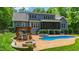 A picturesque backyard features a patio, pool, hot tub, seating area, and lush landscaping for luxurious outdoor living at 7116 Dumfries Ln, Chapel Hill, NC 27514