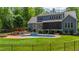 Backyard with a pool, pergola, fire pit, and lush landscaping at 7116 Dumfries Ln, Chapel Hill, NC 27514