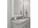 Elegant bathroom featuring granite countertops, sink, and a framed mirror at 7116 Dumfries Ln, Chapel Hill, NC 27514